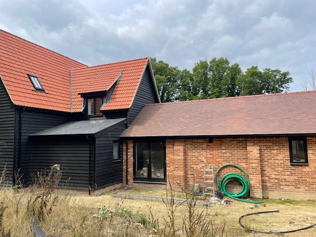 New house and extension with tiled roofing installed by JLR Roofing